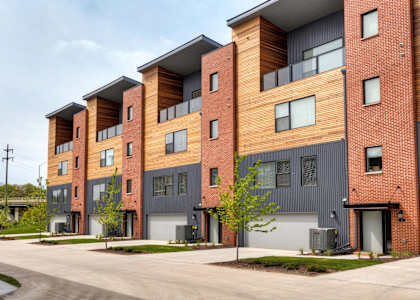 a row of new apartment buildings with a road in front of them at 5Fifty5, Des Moines