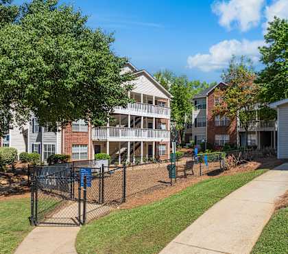 A sunny day at a residential area with apartment buildings and a playground.