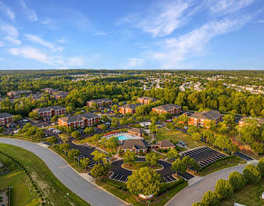 an aerial view of a neighborhood with houses and a swimming pool