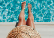 Thumbnail 7 of 16 - Women relaxing near pool at Red Rock Apartments, Rapid City, South Dakota