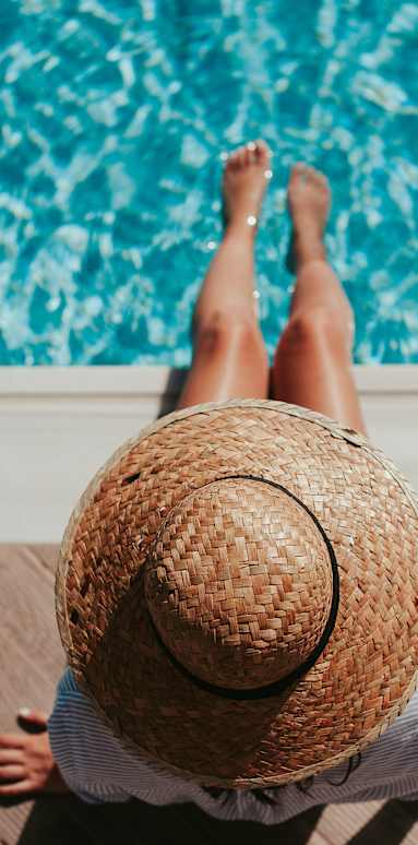 A person relaxing by the pool at Bautista Apartments, Tucson