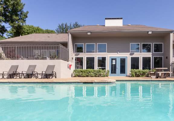 a large swimming pool in front of a house  at The Biltmore, Dallas, Texas