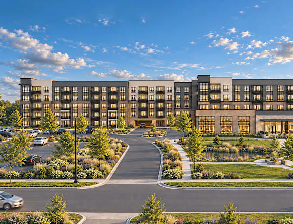 A modern building with a parking lot in front.