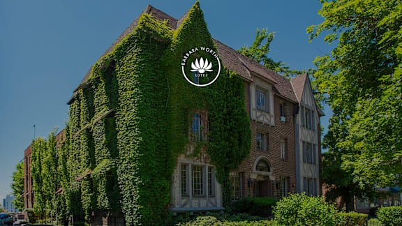 A building with a large amount of ivy growing on it.