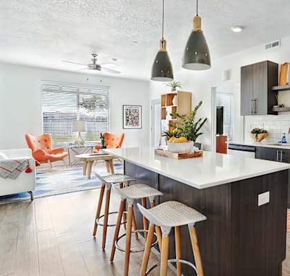 A kitchen with a white countertop and a stainless steel oven.