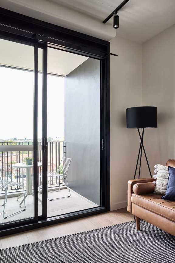 a living room with sliding glass doors to a balcony