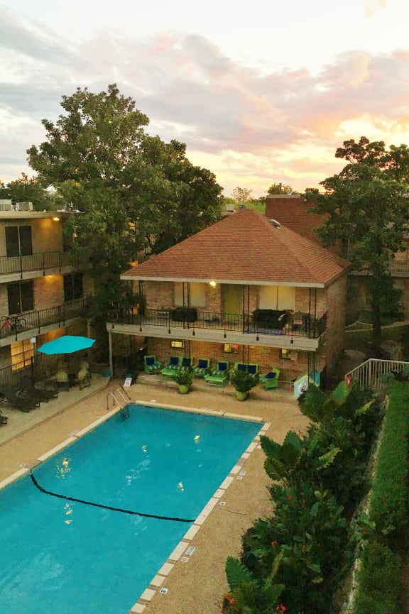 a view of the pool of a resort with a swimming pool