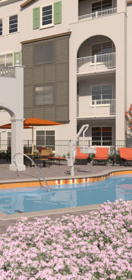 A pool surrounded by a building and flowers.