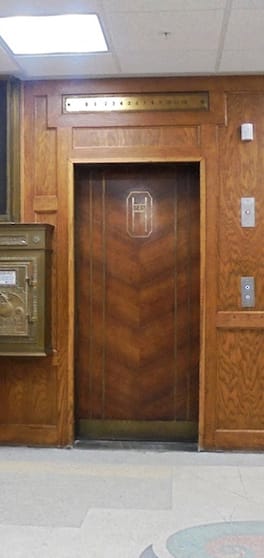 Elevator with beautiful woodwork and vintage metal mailbox