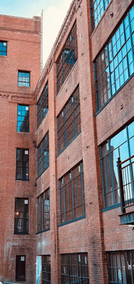 A red brick building with large windows.