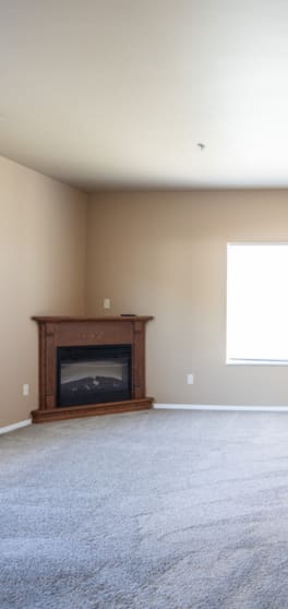 an empty living room with a fireplace