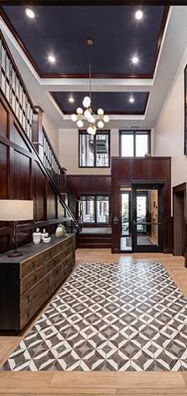 a lobby with a checkered rug and a staircase
