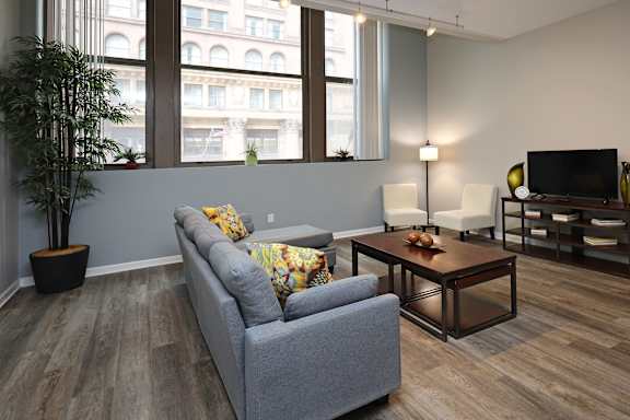 Living room with wooden floor at The Residences at 668 Apartments, Cleveland, 44114