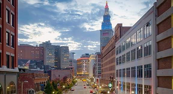 A city street with a tall tower in the background.