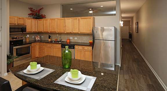 A kitchen with a table set for two.
