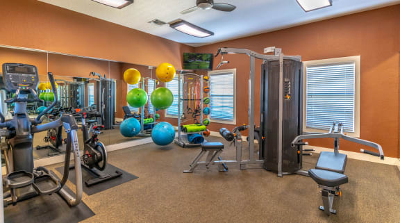a home gym with exercise equipment and weights