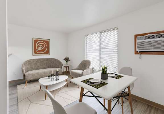 A living room with a couch, chairs, and a dining table at Shiloh Glen Apartments.