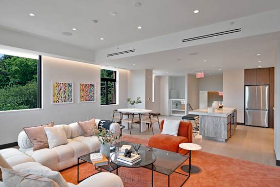 A modern living room with a white couch and a coffee table.