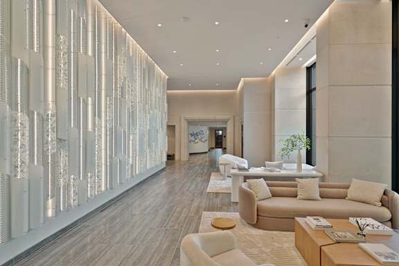A modern living room with a long white column and a couch.