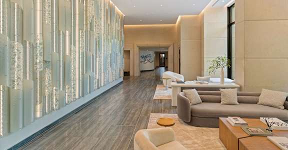 A modern living room with a long glass partition wall.