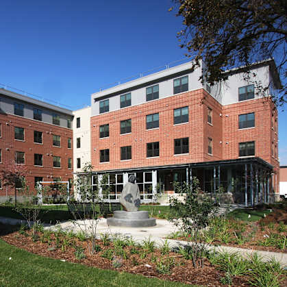 A modern building with a courtyard in front.