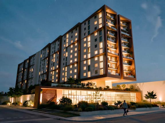 A tall building with a person walking in front of it.