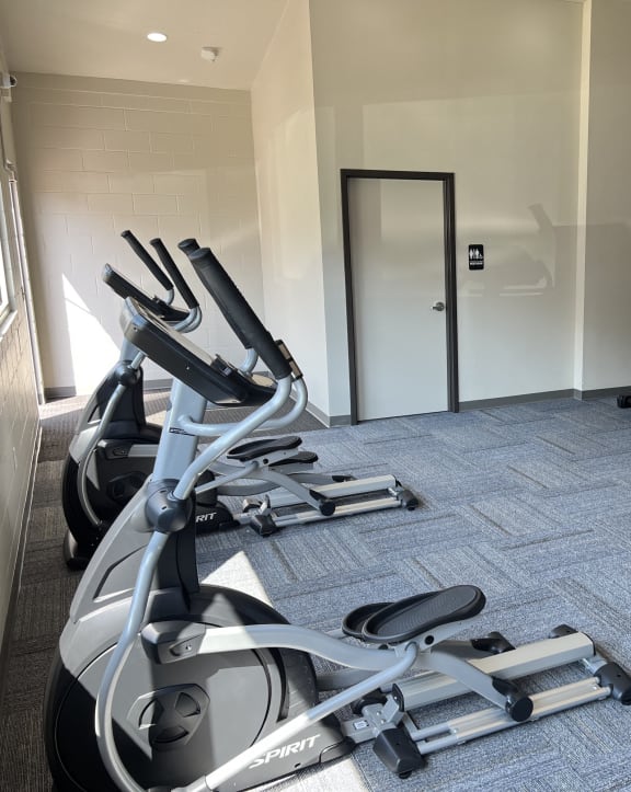 a gym with treadmills and elliptical machines at Courtyard Apartments, Moorhead, MN, 56560