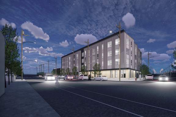 A modern building with a parking lot in front of it.
