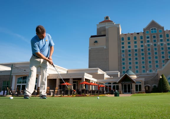 Man playing golf at the Grandover Resort and Spa