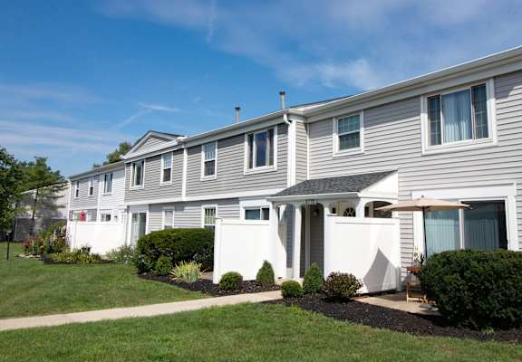 A row of houses with a clear blue sky above them.