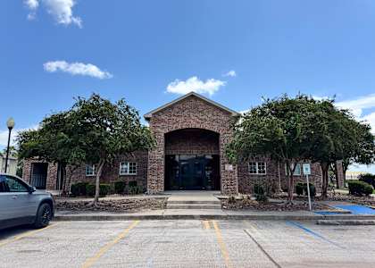 A building with a brick facade and a large entrance.