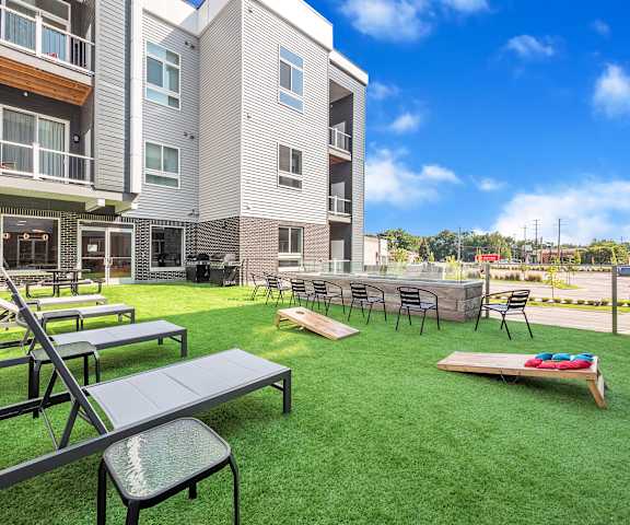 A sunny day at the outdoor seating area of a modern apartment complex.