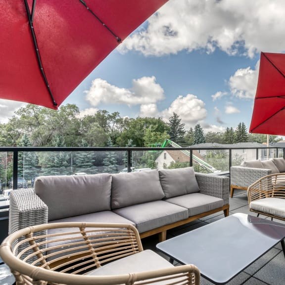 a patio with couches and chairs and umbrellas at Southpark on Whyte, Edmonton, Alberta, T6E 3S3