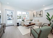 Thumbnail 5 of 7 - Living Room with a Green Chair at Woodland Place Apartments, Langford, British Columbia