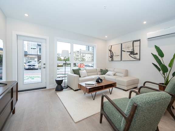 Living Room with a Green Chair at Woodland Place Apartments, Langford, British Columbia