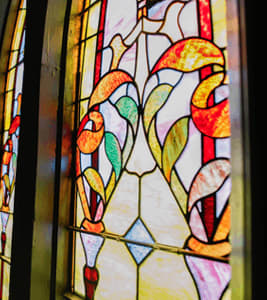 A stained glass window with a design of leaves and vines.