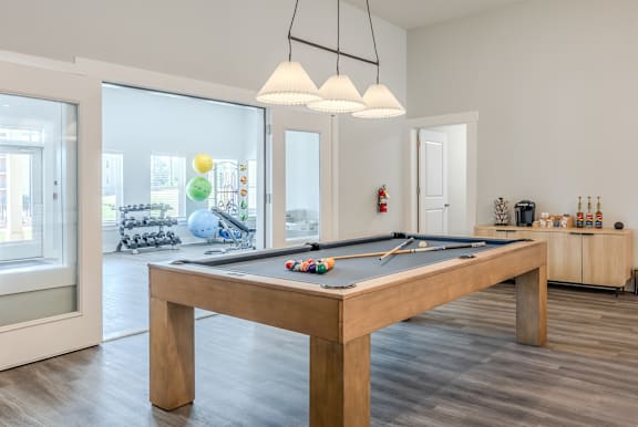 a games room with a pool table in a house