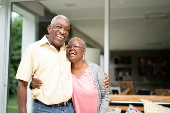an older man and woman standing together and laughing at The Grainwood Senior, Minnesota, 55372