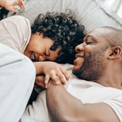 a man and woman laying in bed together