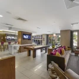 a living room filled with furniture and a flat screen tv