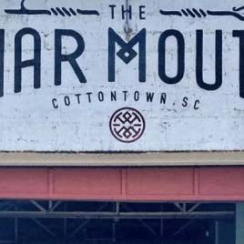 a white building with a sign on the front of it