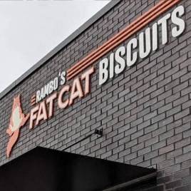 a brick building with a sign that biscuits
