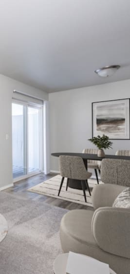 A living room with a grey couch and a black table.