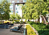 Thumbnail 4 of 26 - The courtyard has ample patio seating, two outdoor gas grills, a fireplace, and a ping-pong table