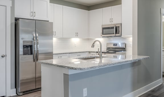 a kitchen with stainless steel appliances and a granite counter top