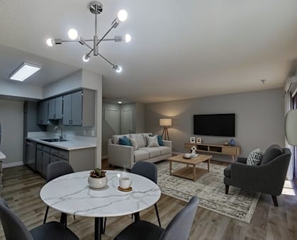 A modern living room with a dining table and grey chairs.