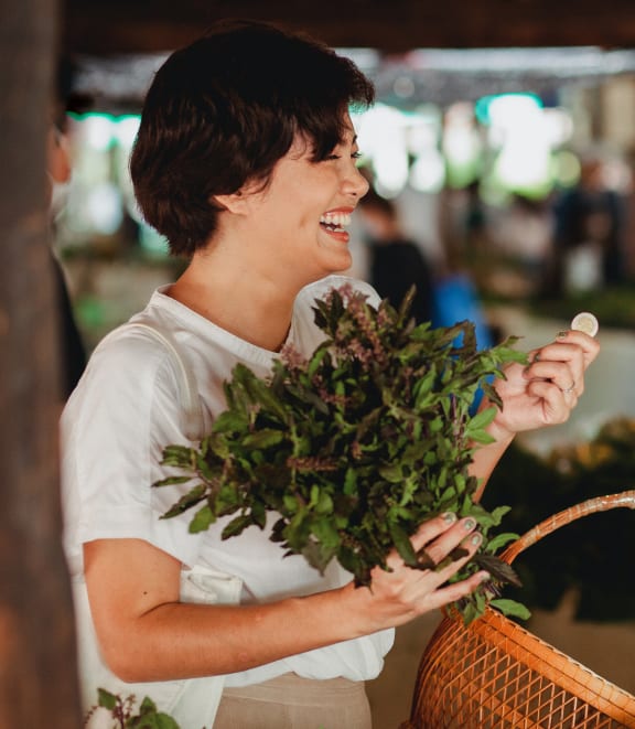a man holding a basket of vegetables