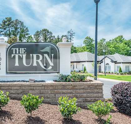 The Turn 103 sign is in front of a building.