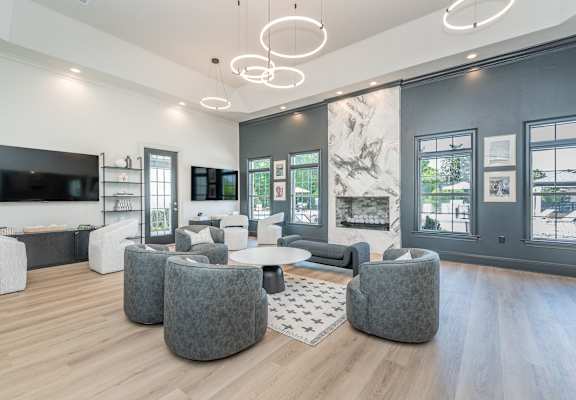A modern living room with a grey and white color scheme.