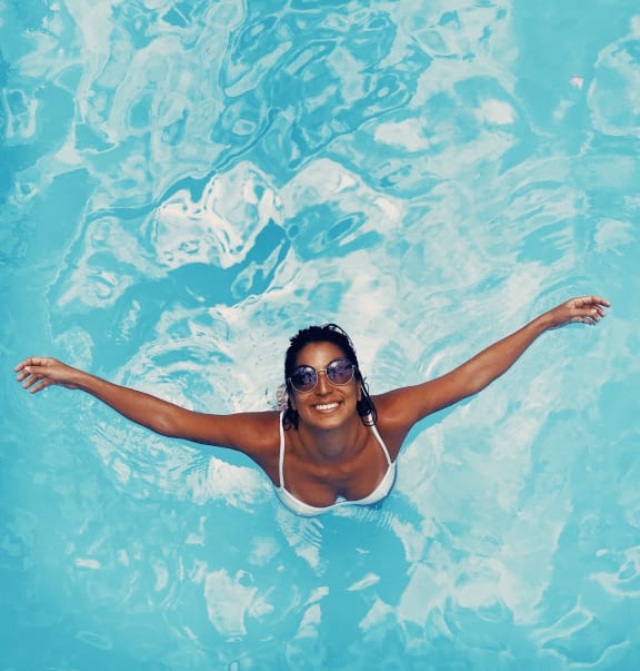 a woman swimming in a swimming pool